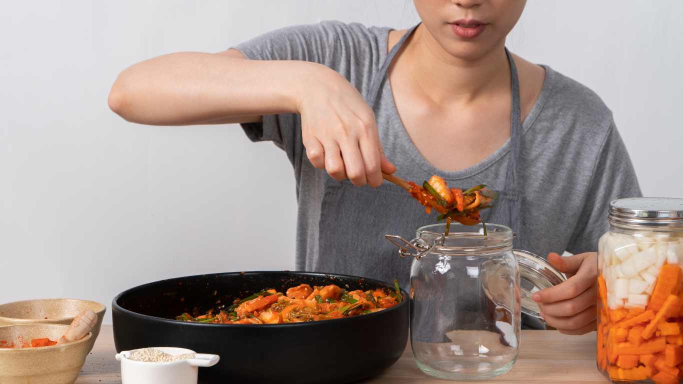 Asian woman making kimchi