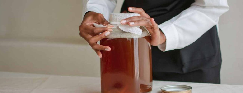 Woman making kombucha with SCOBY 